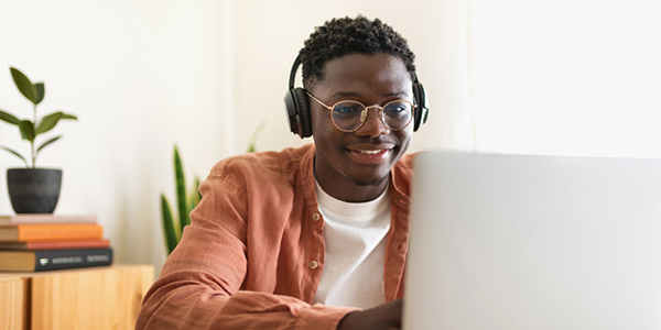 job seeker on their laptop smiling