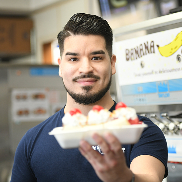 Daniel Cuevas '24 holds a freshly made banana split.