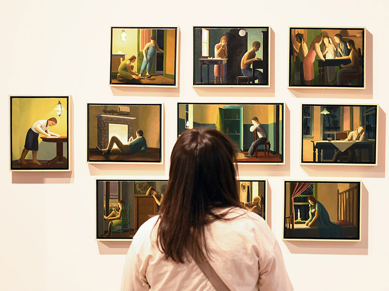 Student looking at art exhibit