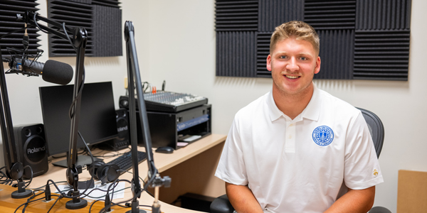 JP Chaney at a podcasting desk.