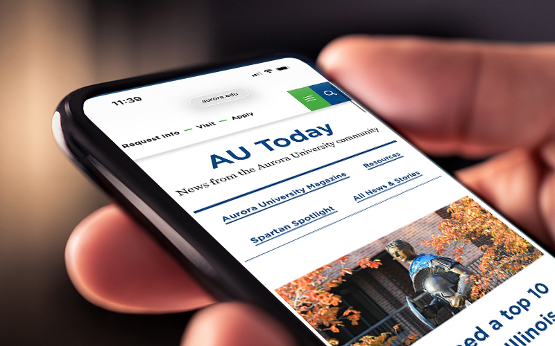 Phone with AU blog on screen.