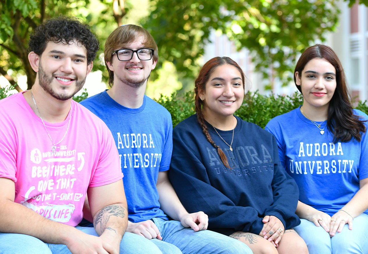students sitting on campus in the spring