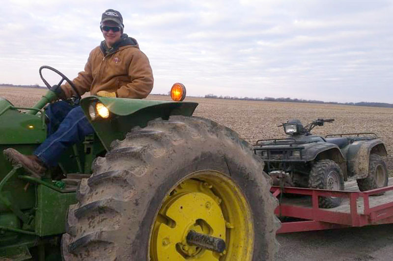 Bryce on a tractor as an adult.